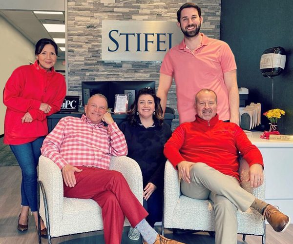 From left to right: Maria O'Neill, John W. Ridley, Linsay Tambling, Drew Martin, Derek Hull, dress in Western Kentucky University colors at the front desk of their Stifel office