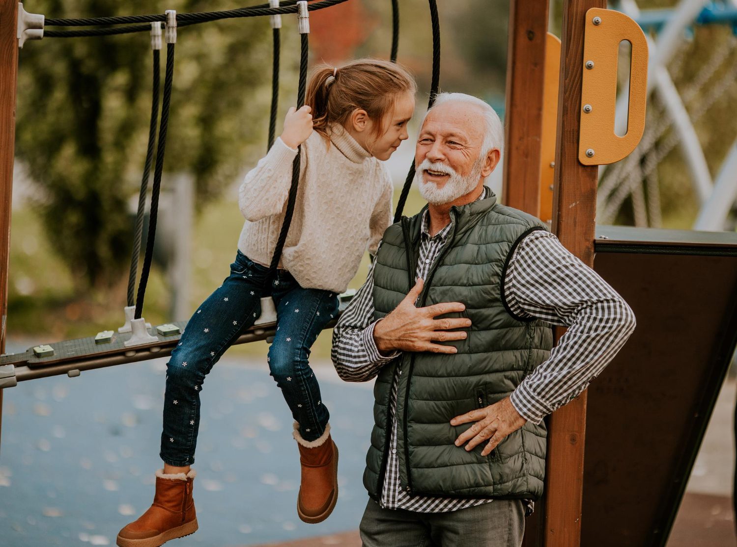 Grandfather at playground with grandchild
