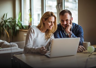 couple looking at laptop at home