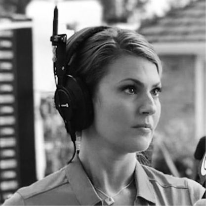 Black and white image of Amanda Balionis with headphones on