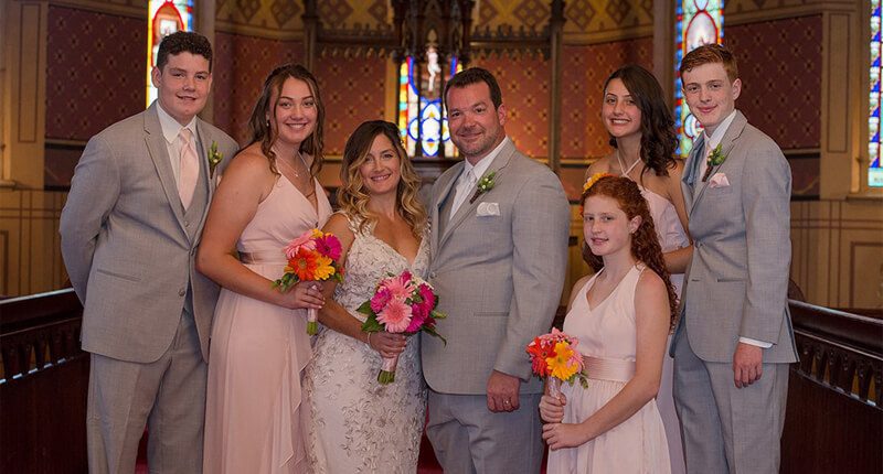 Chris Kerstin's wedding with his bride and children in a church