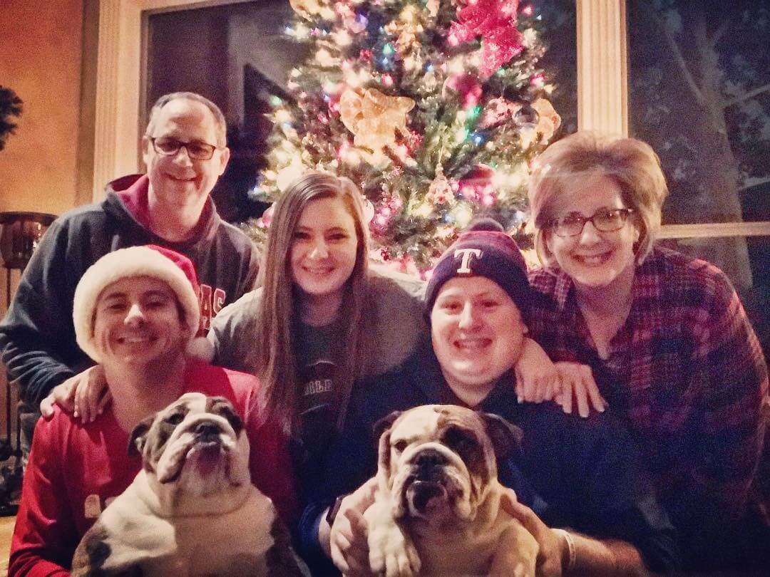 Eddie Caldwell's family in front of a Christmas tree