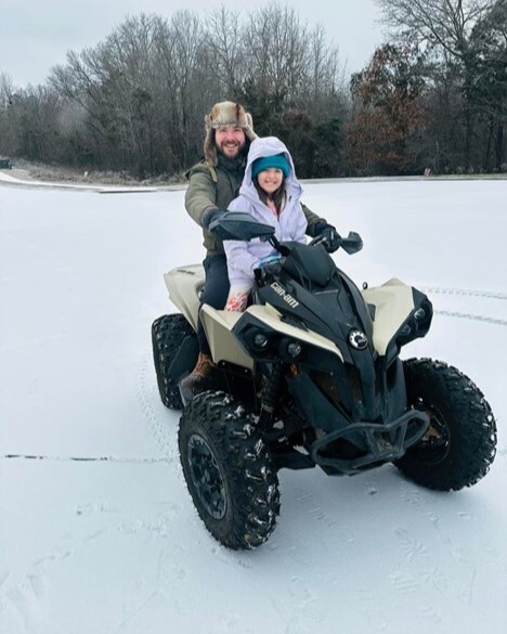 Ryan and daughter on ATV in Winter