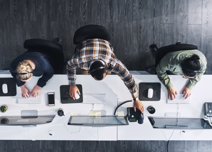 3 People sitting at desk working