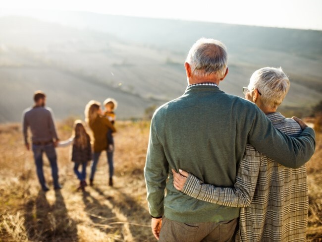 Retired couple watching their children and grandchildren