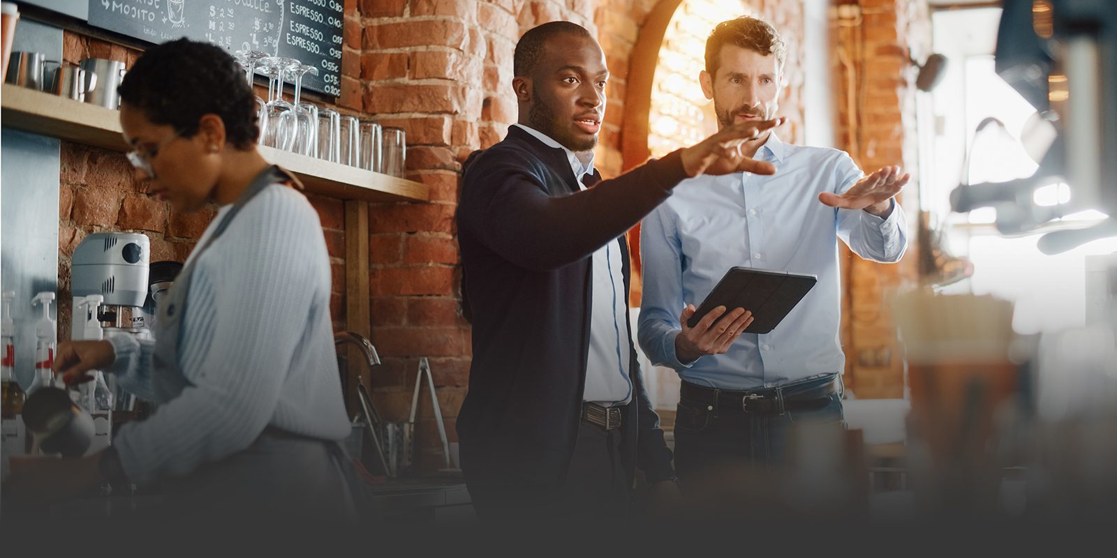 business owners talking with employee