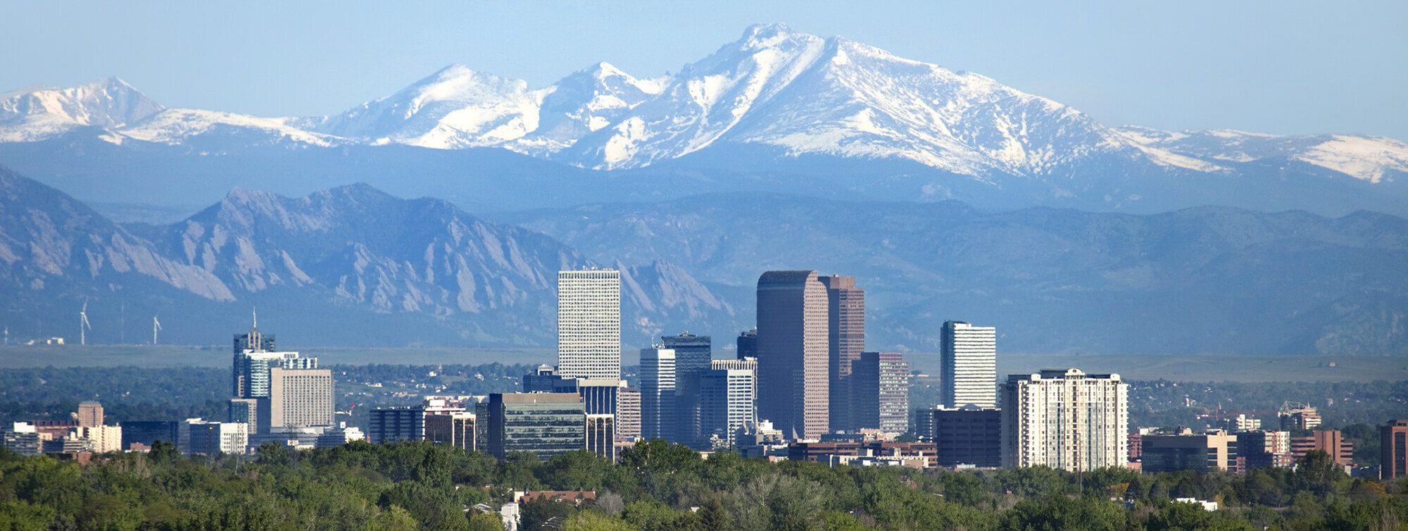Denver Colorado skyline with Rocky Mountains &mdash; Four Corners Financial Advisors Denver