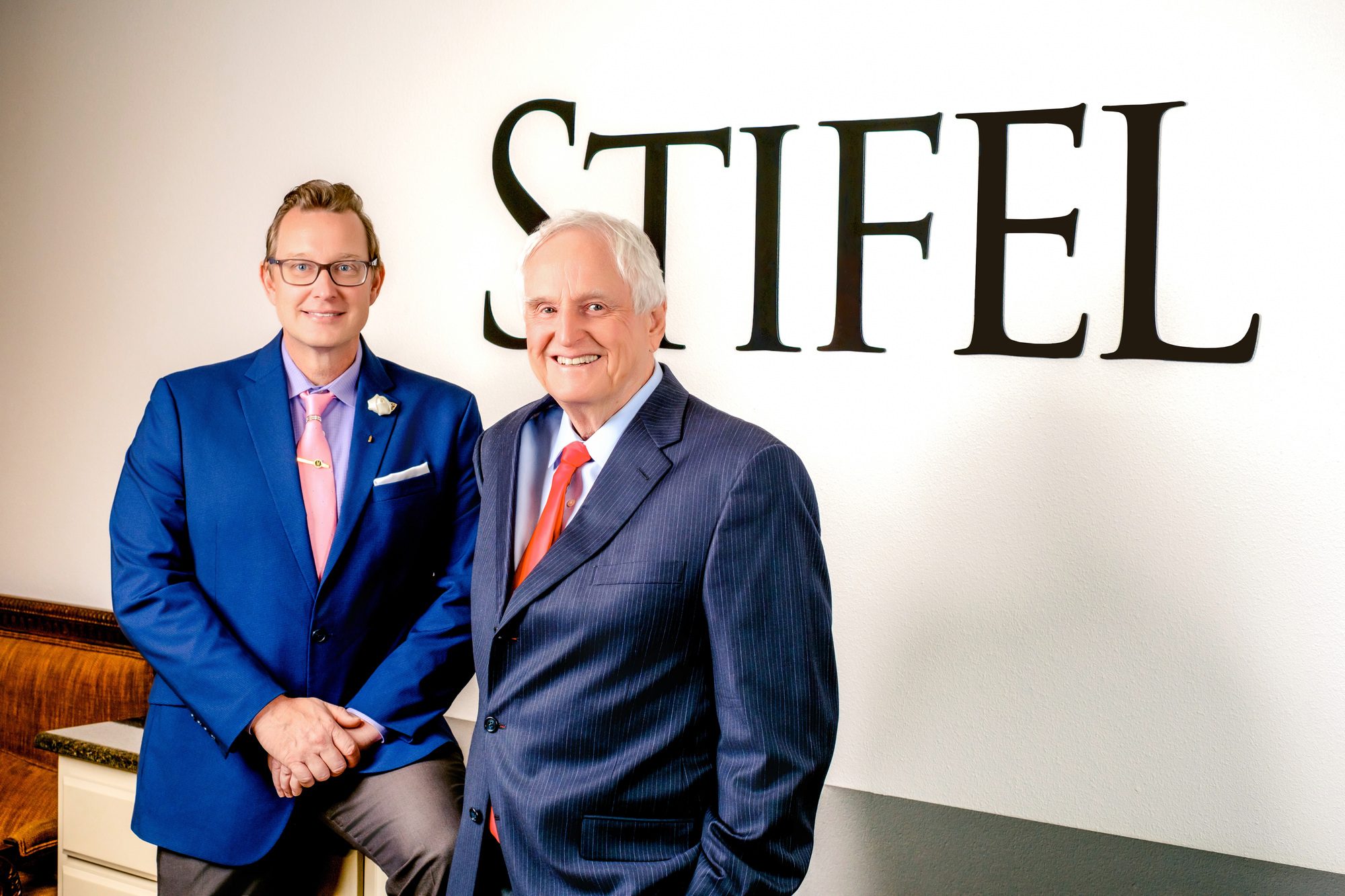 Nick and Steve Myatt posing in front of the welcome desk at the Stifel Waco branch