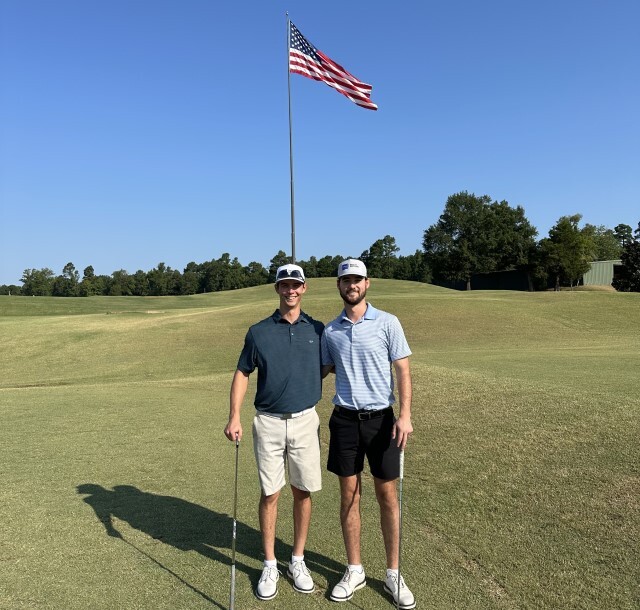 Nick and a friend playing golf.